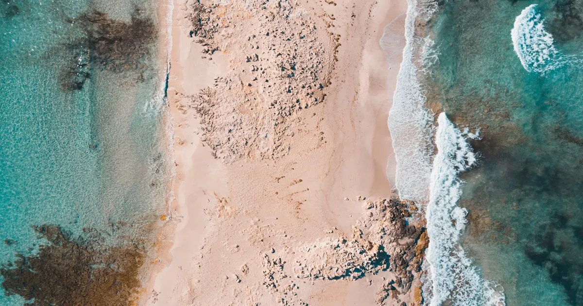 Boat crossing the turquoise channel between Ibiza and Formentera with clear blue water