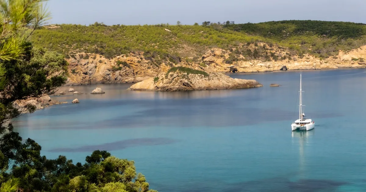 Aerial view of a hidden turquoise cove in Ibiza accessible only by boat
