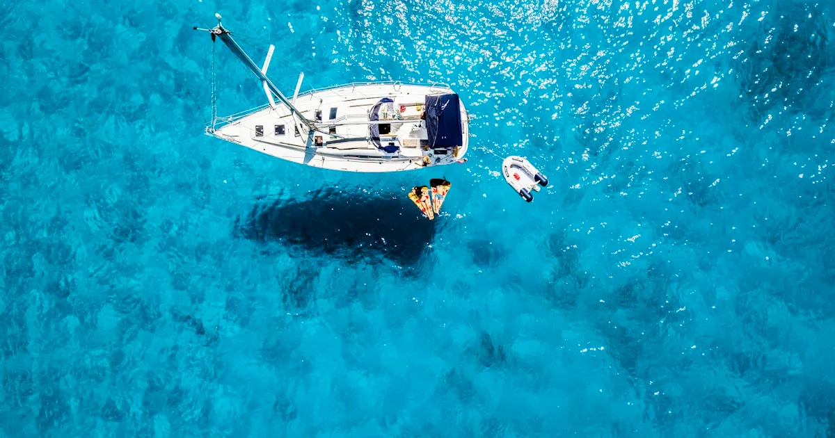 Small motorboat cruising along the turquoise coast of Ibiza without a license
